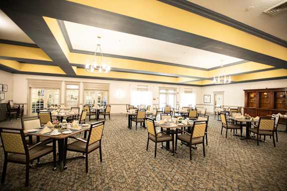 A large dining room with tables set for dining.