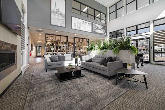 A living room with a grey couch and a coffee table.