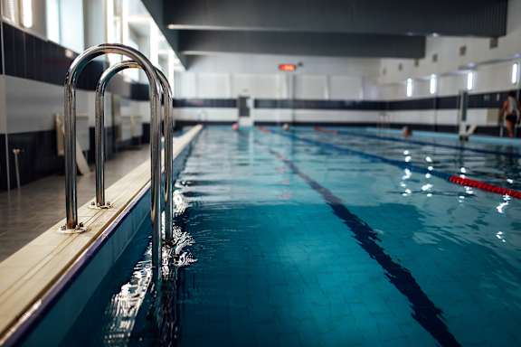 A swimming pool with a diving board.