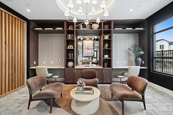 A modern living room with brown leather chairs and a white coffee table.