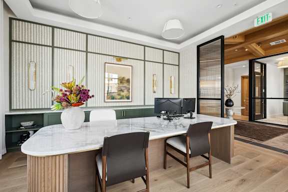 A modern conference room with a white table and chairs.