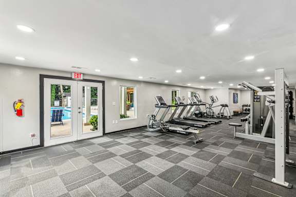 A gym with treadmills, weights and exercise machines.