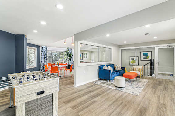 A foosball table is in the middle of a living room.