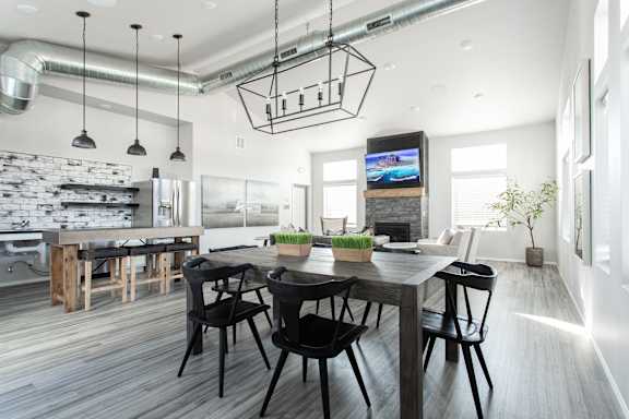 A modern dining room with a wooden table and chairs.
