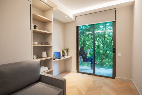 a person sitting on a chair in a room with a window