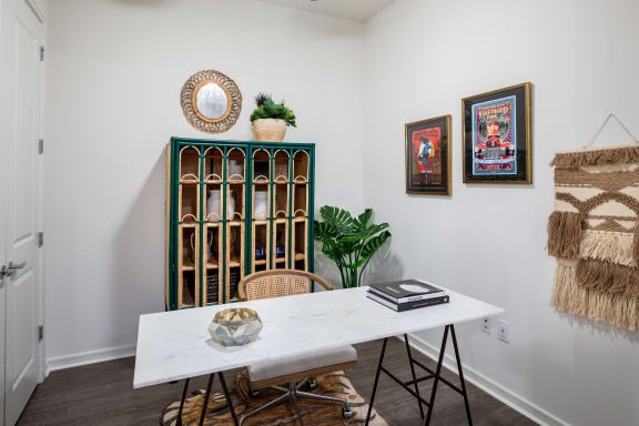 a dining room with a white table and chairs