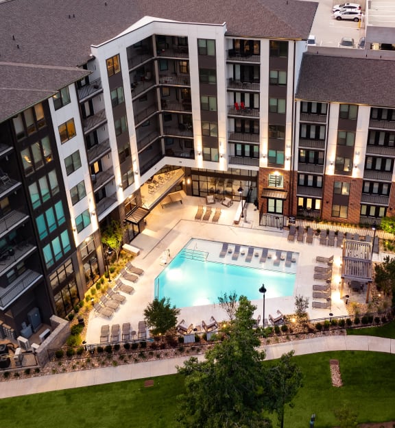 an aerial view of an apartment building with a swimming pool
