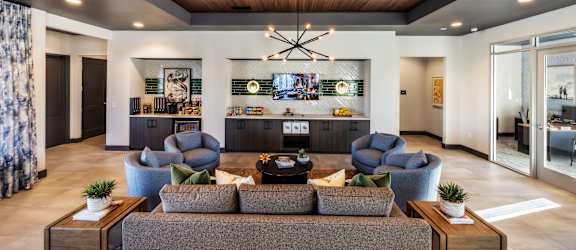 A modern living room with a wooden ceiling and a large sectional sofa.