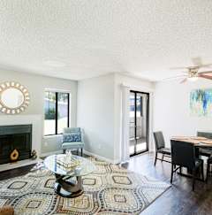 A room with a fireplace and wooden floors.  at Water Ridge Apartments , Texas, 75061