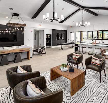 a large living room with couches chairs and a table