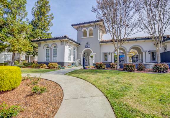 a home with a walkway leading to the front door