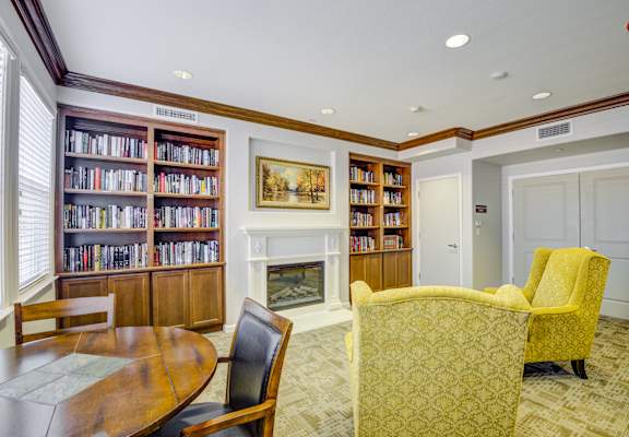 a room with a fireplace and a table and chairs