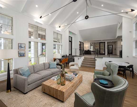 a living room with couches and chairs and a table