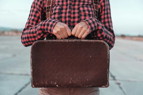 a man is holding a suitcase at Savannah Grand of Sarasota, Sarasota, 34238
