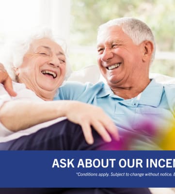 an elderly couple sitting on a couch with the text ask about our incentives