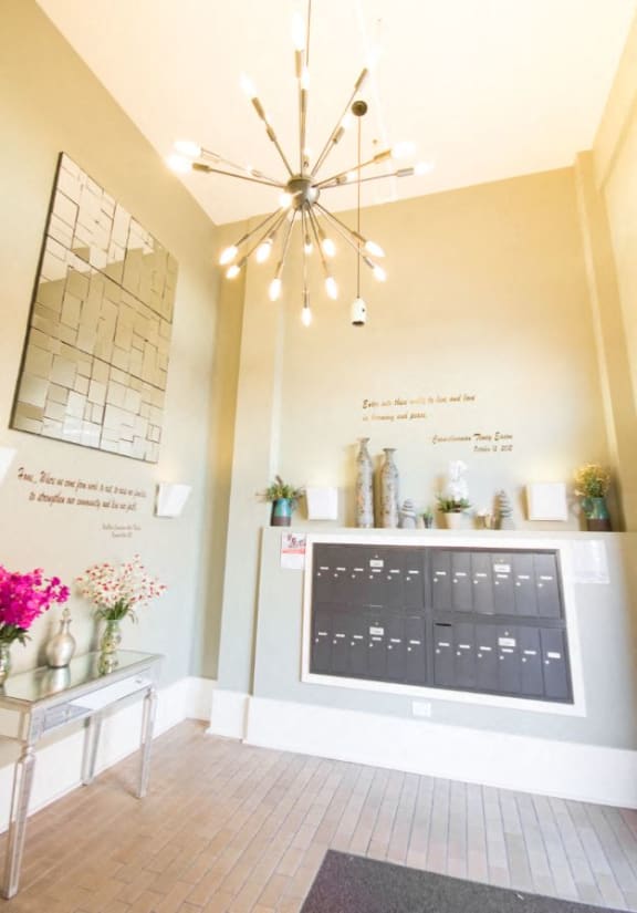 Mail room with mail boxes and geometric chandelier