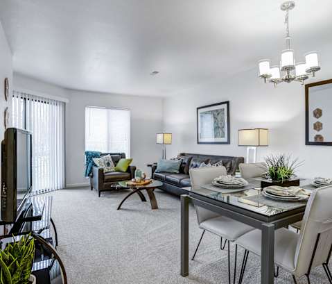 an open living room and dining room with a table and chairs