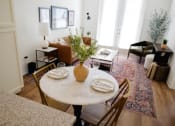 Thumbnail 5 of 34 - a dining room table with a vase of flowers on top of it