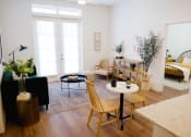 Thumbnail 6 of 34 - a living room filled with furniture and a large window