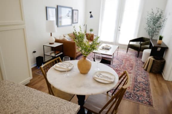 a dining room table with a vase of flowers on top of it