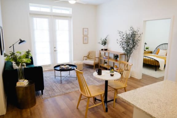 a living room filled with furniture and a large window