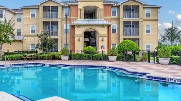 a swimming pool in front of an apartment building
