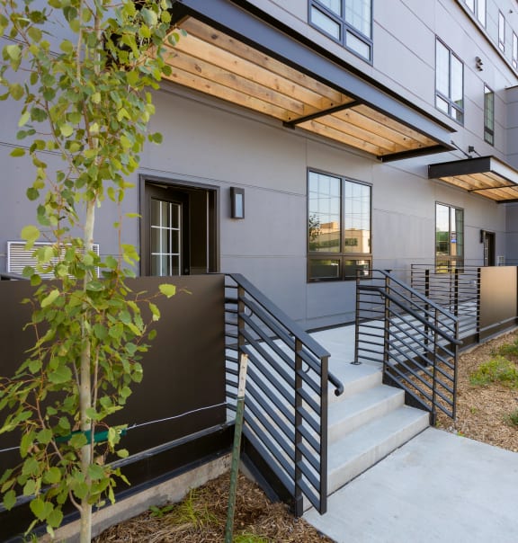 the side of a building with stairs and a sidewalk at The Landing at 1001 NP, Fargo, ND 58102
