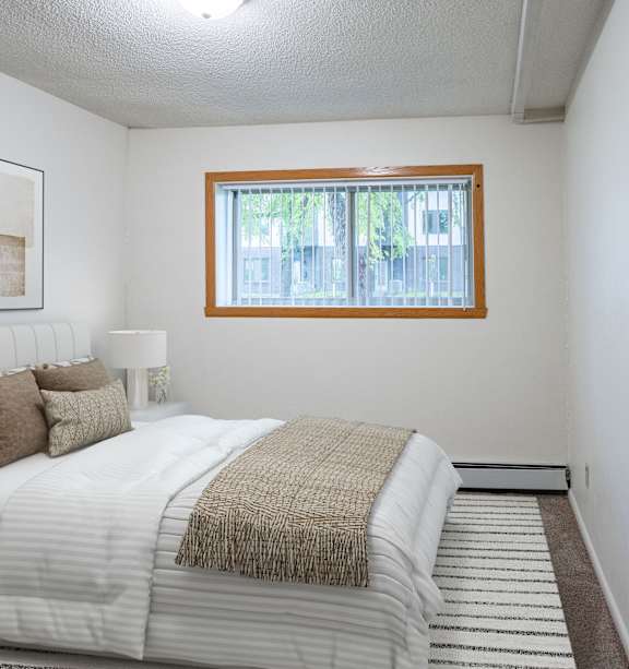 Fargo, ND Park Terrace Apartments | 21C | Bedroom a blue building with a lawn and a fire hydrant in front of it
