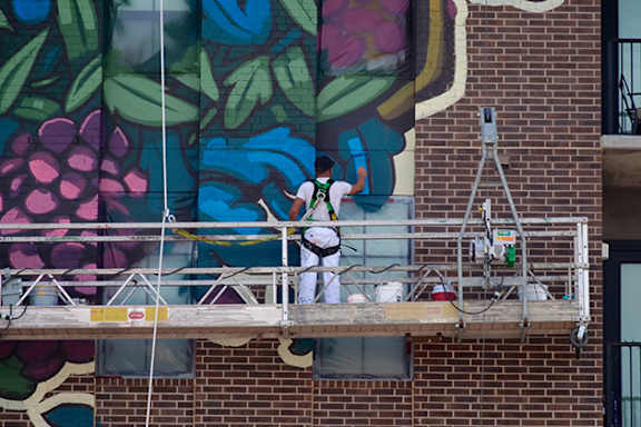 artist paiting on the wall