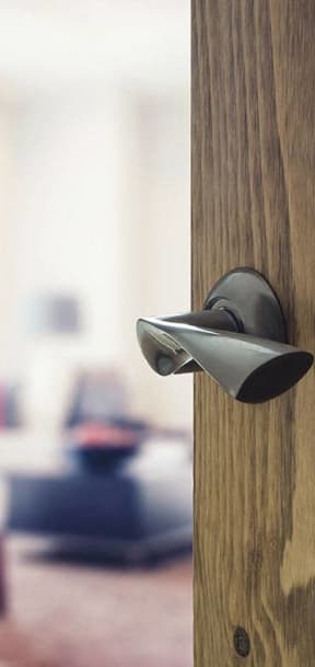 a door handle with a living room in the background