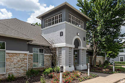 the front of a house with a walkway and landscaping
