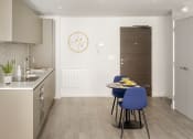 Thumbnail 4 of 12 - a kitchen and dining area with a table and chairs
