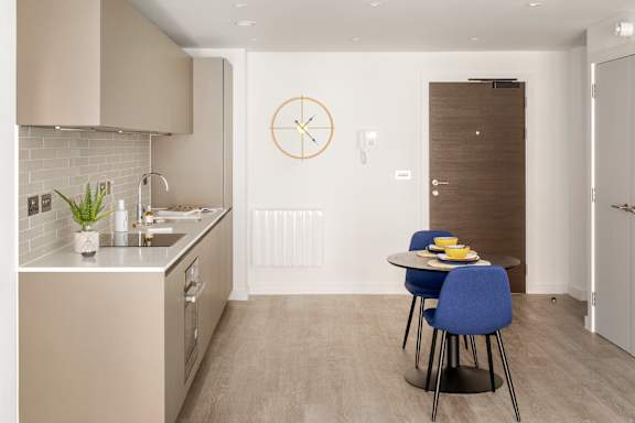 a kitchen and dining area with a table and chairs