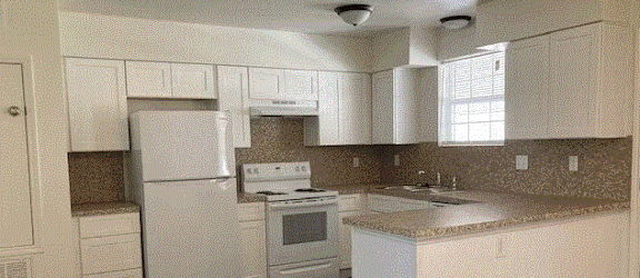 a kitchen with white appliances and white cabinets