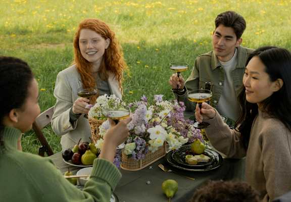A group of people are having a picnic in a field.