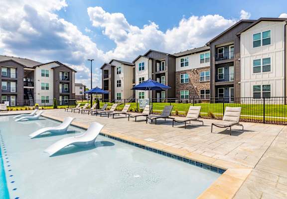 our apartments offer a swimming pool with lounge chairs and umbrellas