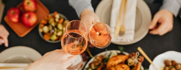 people sitting around a table drinking wine and eating food