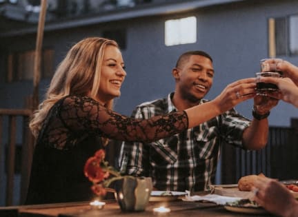 a man and a woman sitting at a table with drinks