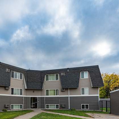 a large apartment building with a roof shaped like a pyramid