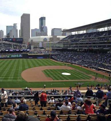 A baseball stadium is filled with fans watching a game.