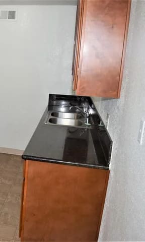 a kitchen with a refrigerator and a stove and a sink