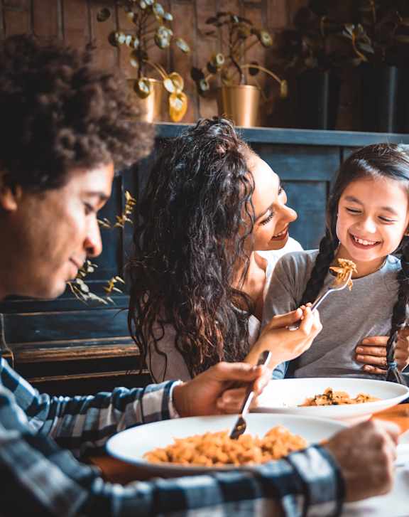 A group of people enjoying a meal together at a restaurant.