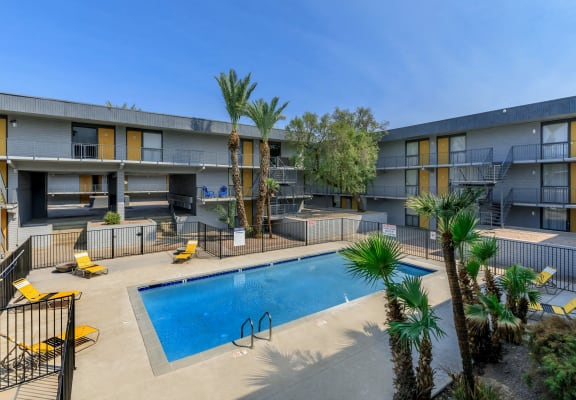 a pool is shown at an apartment building with palm trees