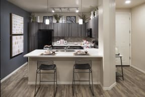 an open kitchen with a large island with two stools