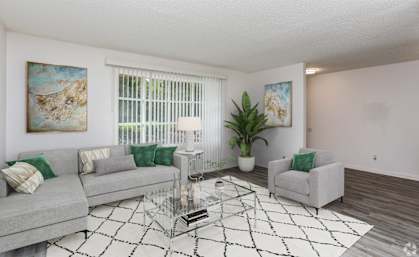 a living room with couches and a glass coffee table