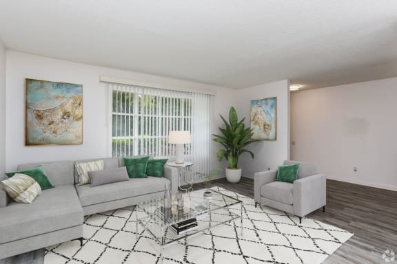 a living room with a couch and a ceiling fan