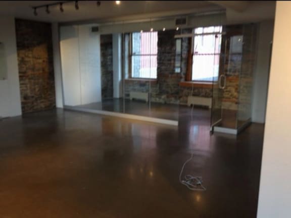 A room with a stone wall and a large window.