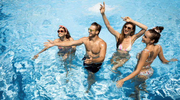 a group of people in a swimming pool at Birdie on Woodland Greens, Austin, Texas