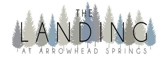 The image is a logo for "The Landing at Arrowhead Springs" with a forest of trees in the background.