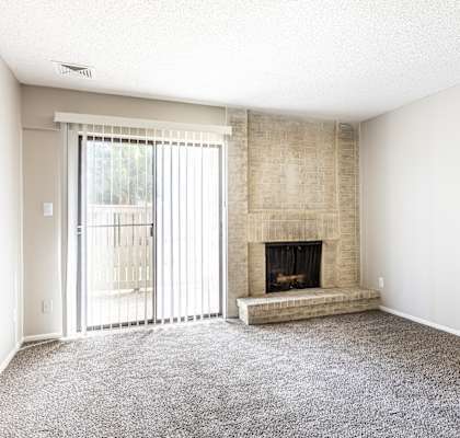 a living room with a fireplace and a sliding glass door